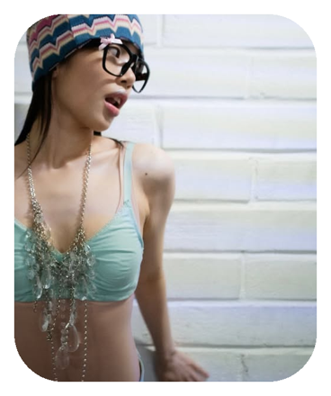 Layered silver chain necklaces styled over a baby blue top